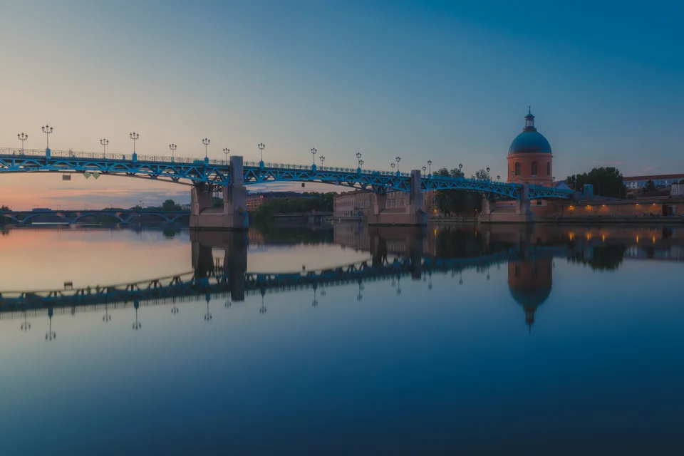 A bridge and dome mirrored in the river