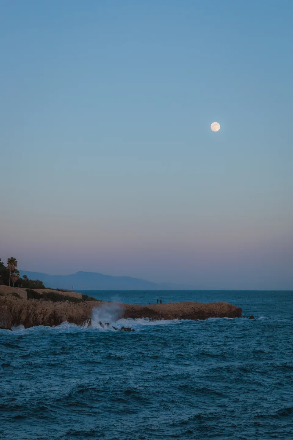 Moon over a rocky coast