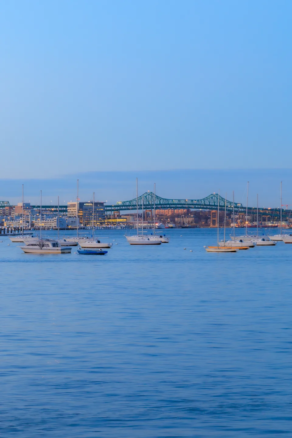 A harbour and bridge at dusk