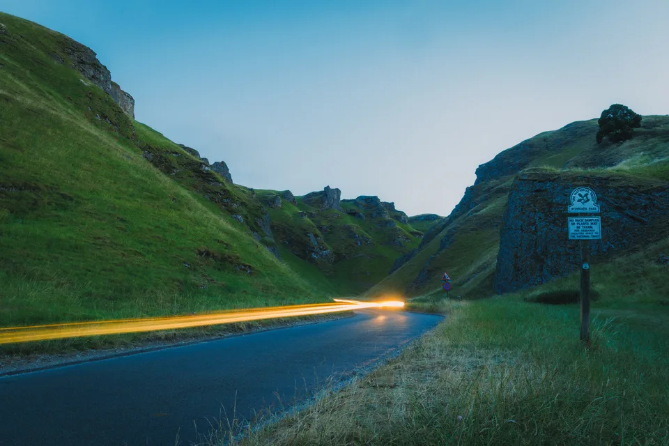 A trail of headlights through the hills