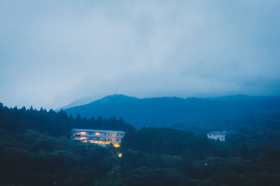 A lit building in the blue hills