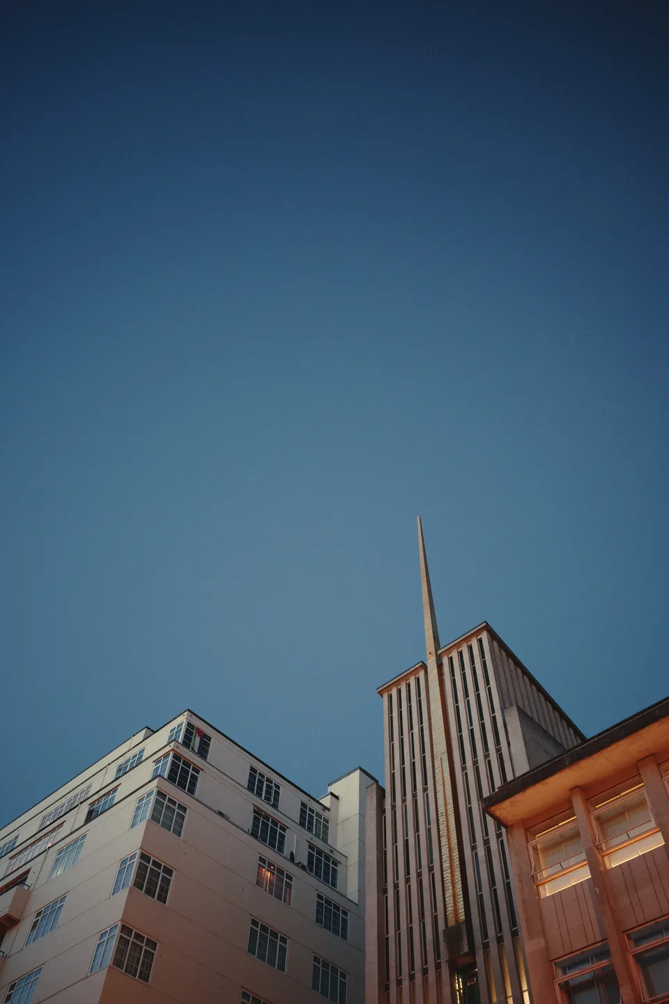 Rooftops against a deep blue sky