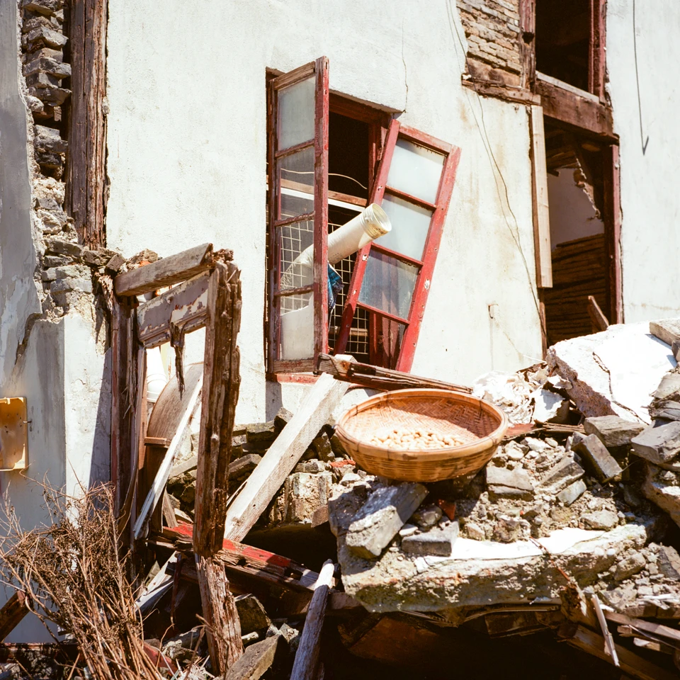 A broken window frame in the rubble