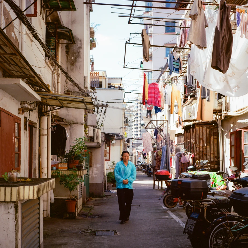 A woman in blue under the washing lines