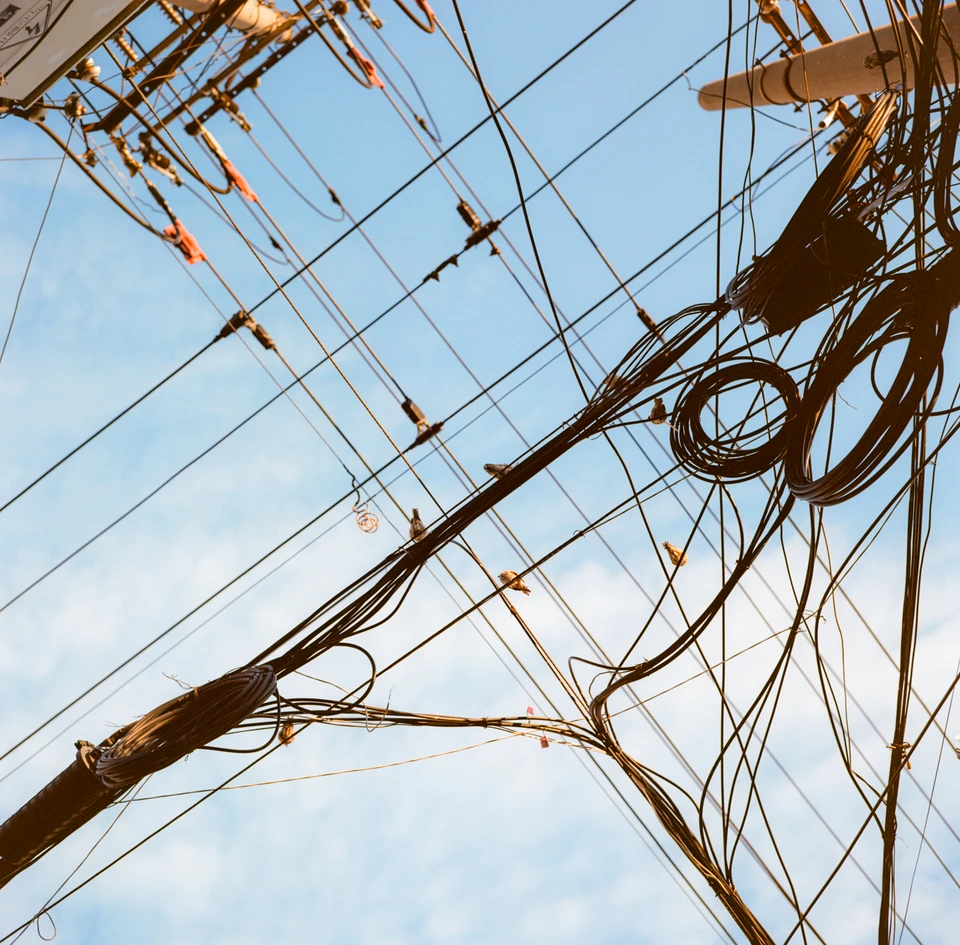 Tangled power lines against the sky